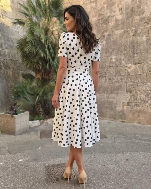 Elegant polka dot dress with a V-neckline and a flower